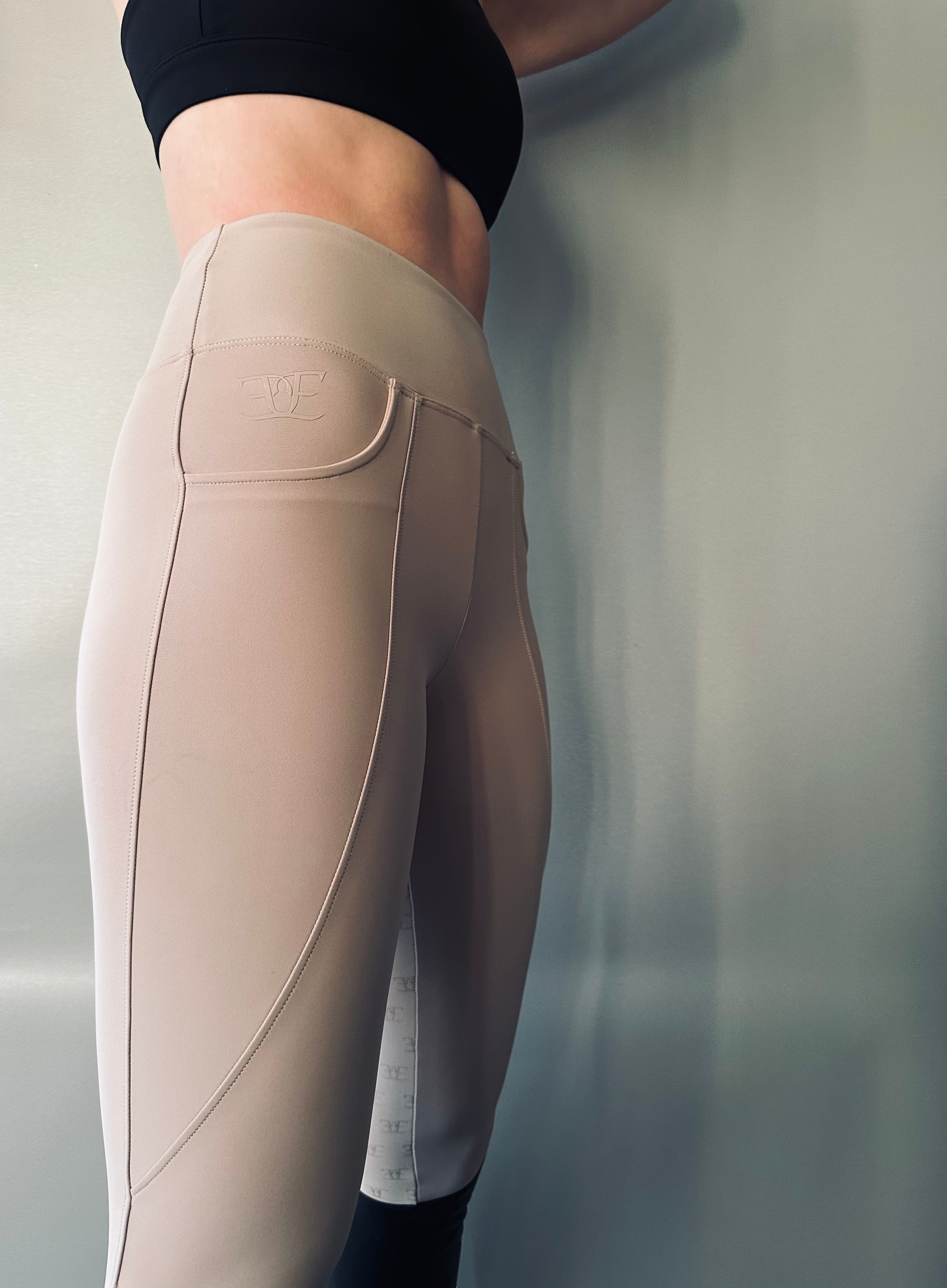 Beige high-waisted leggings with pockets for riding tights and breeches enthusiasts