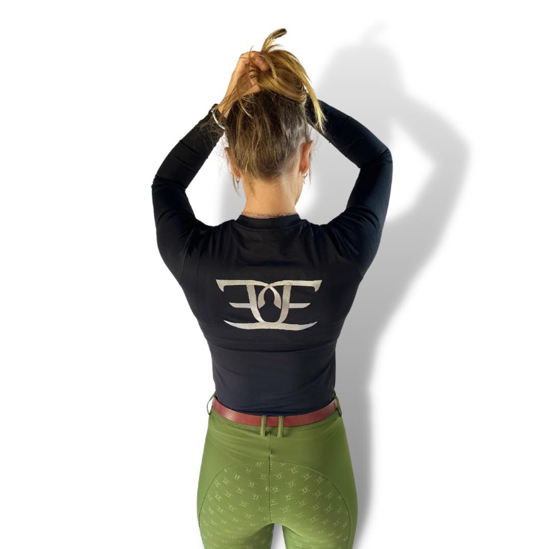 Person in Black Long Sleeved X-training Shirt and green pants, ideal for riding tights
