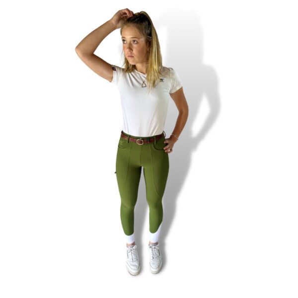 Young woman in white t-shirt and olive green breeches shoes, showcasing Classic Olive XT