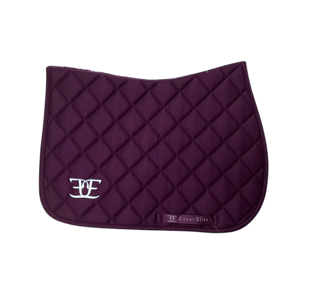 Purple quilted saddle pad with white logo for stylish riding tights and breeches