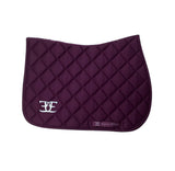 Purple quilted saddle pad with white logo for stylish riding tights and breeches