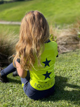 Person with long blonde hair in bright yellow star shirt, perfect for breeches or riding tights