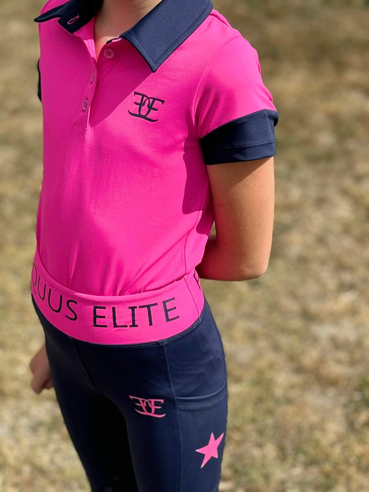 Bright pink and navy blue Kids Matching Polo with STYLUS ELITE branding for riding tights