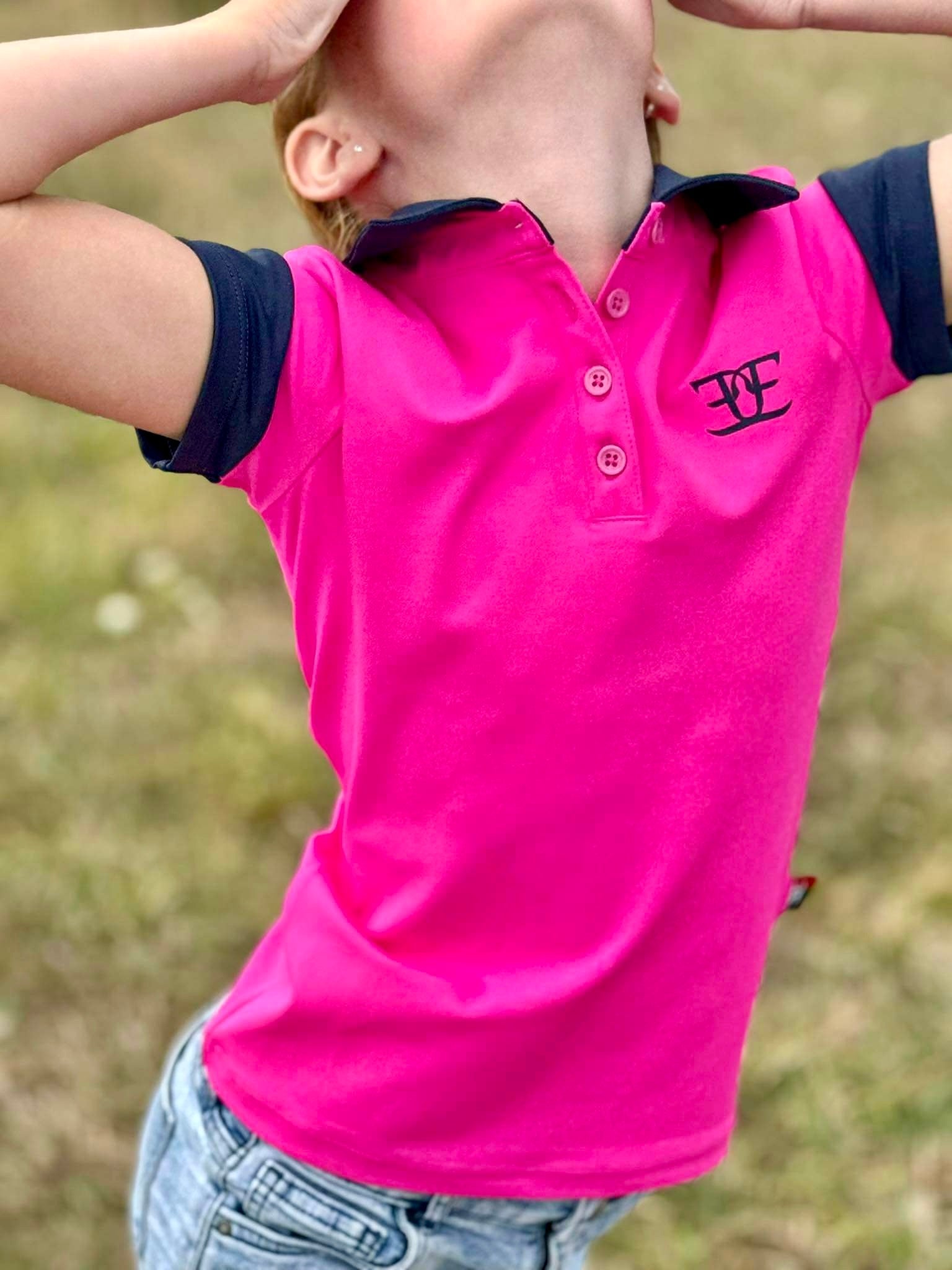 Bright pink kids matching polo shirt featuring logo, perfect for riding tights and breeches